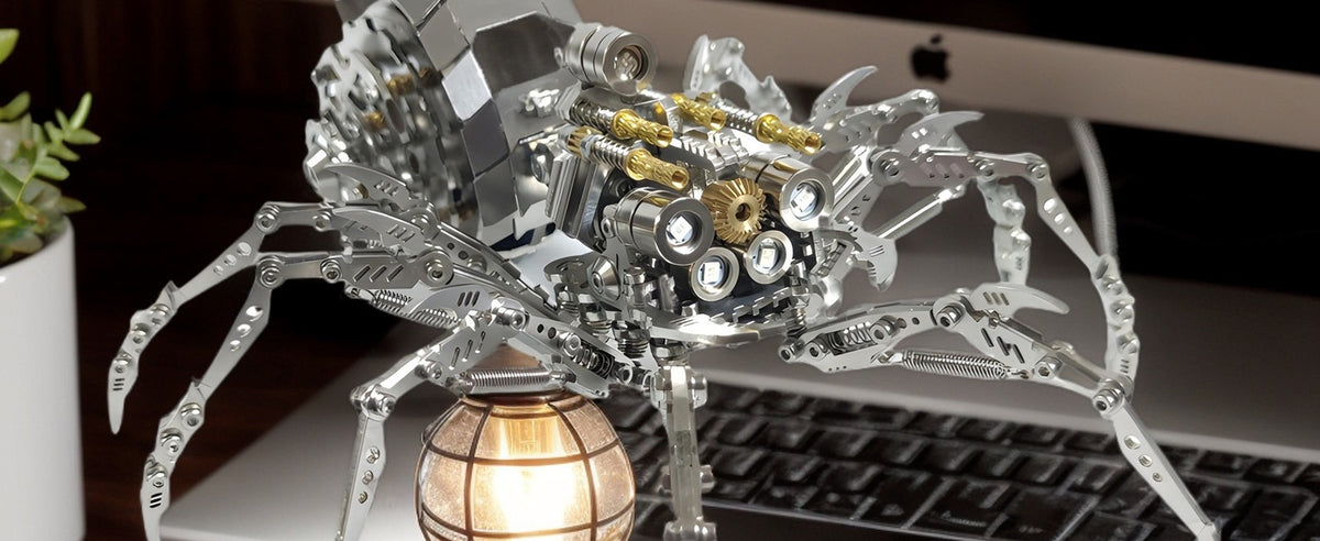 Metal spider displayed beside a laptop